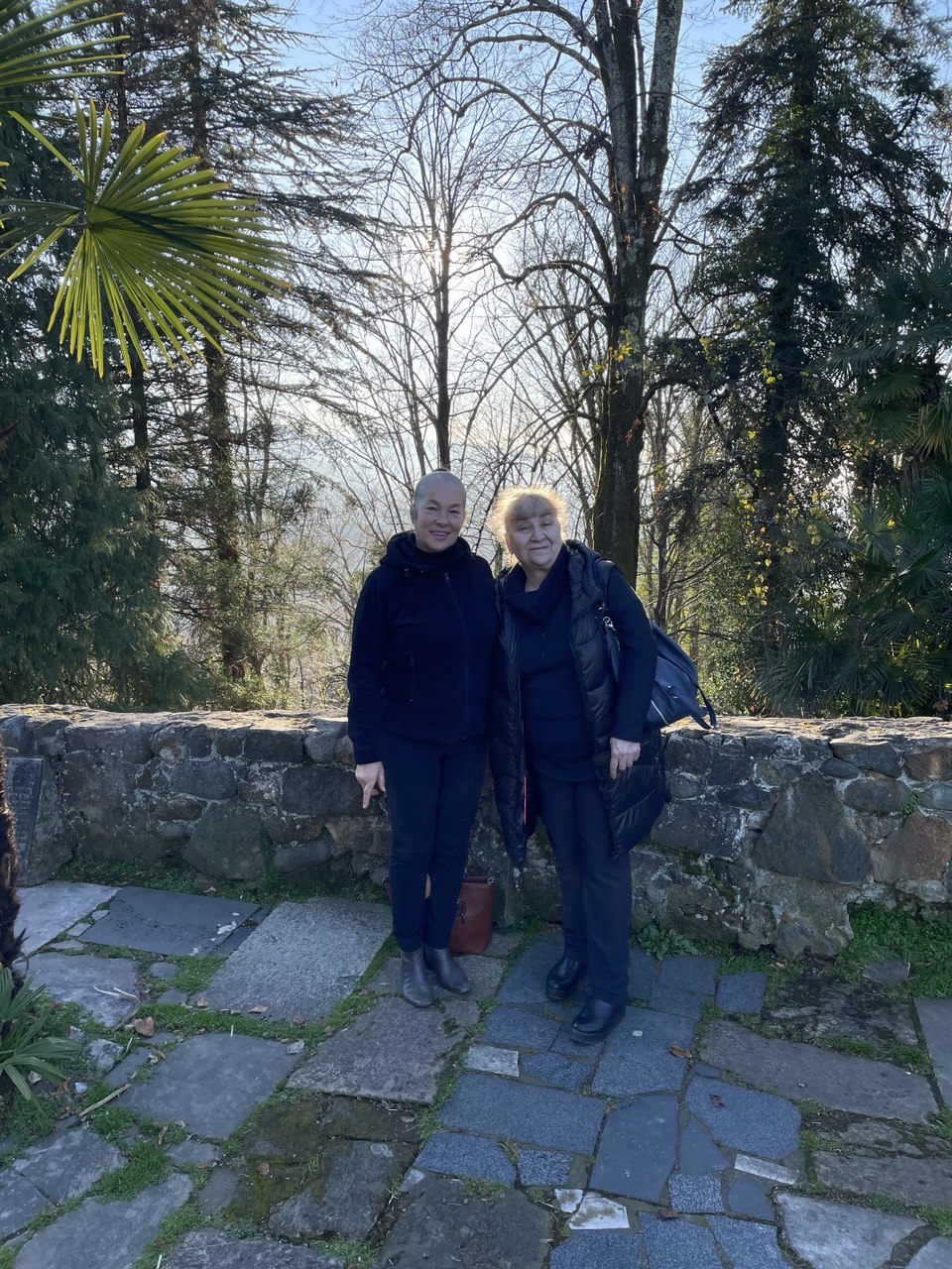 Two women standing in a garden